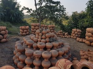 Round brown mud pottery displayed majuli