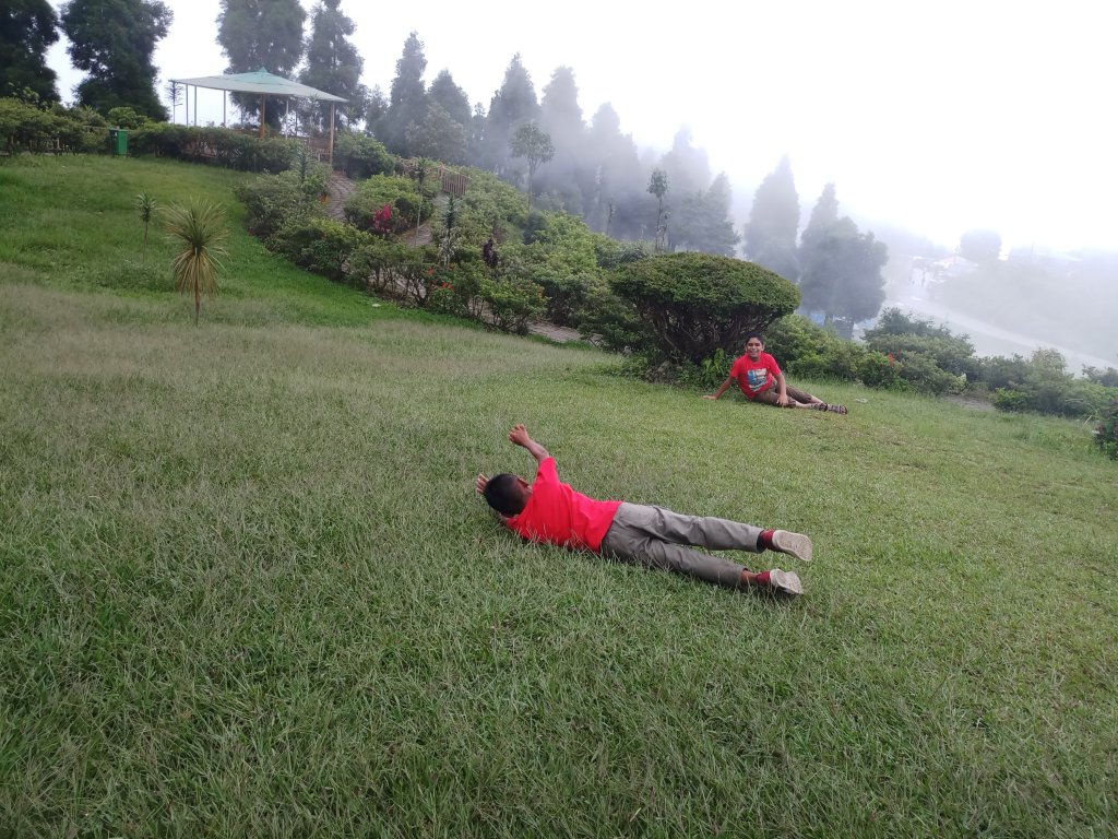 Kids rolling over ground in Delo Park Kalimpong